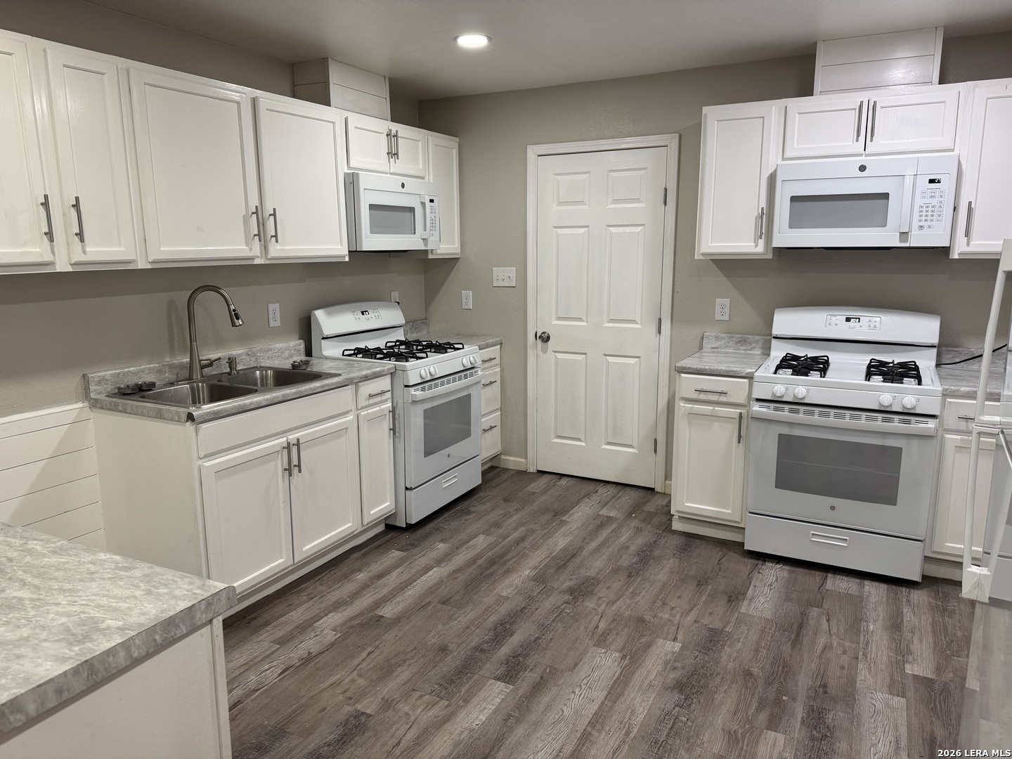 1240 Rice Road San Antonio, TX 78220 - Photo 7 of 45 a kitchen with stainless steel appliances granite countertop a stove a sink and a microwave
