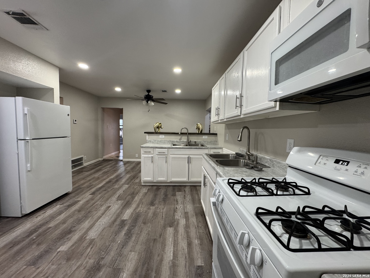 1240 Rice Road San Antonio, TX 78220 - Photo 9 of 45 a kitchen with stainless steel appliances a refrigerator a sink and white cabinets