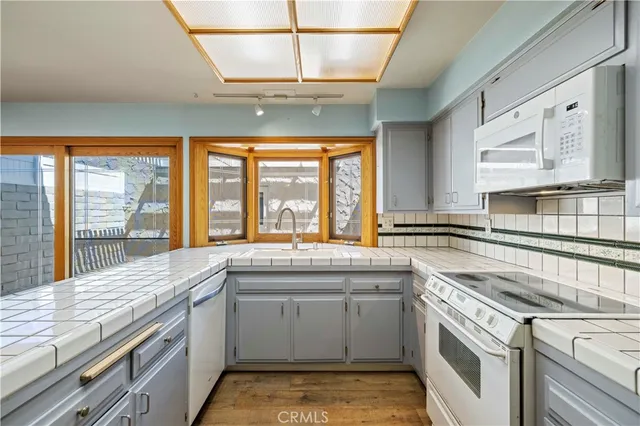 a kitchen with stainless steel appliances granite countertop a stove and a sink