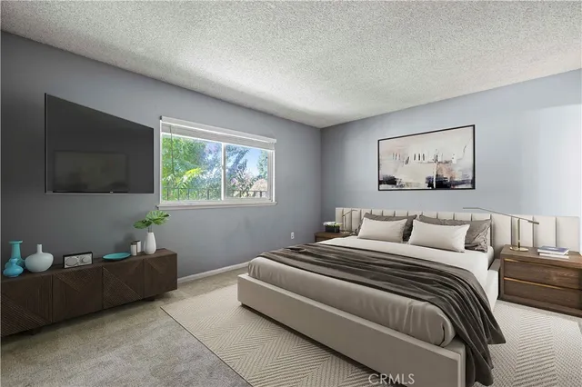 a bedroom with a bed and a flat screen tv