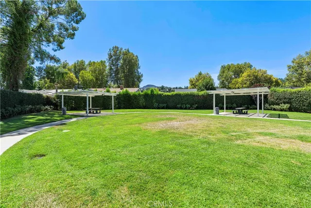 a view of house with a backyard