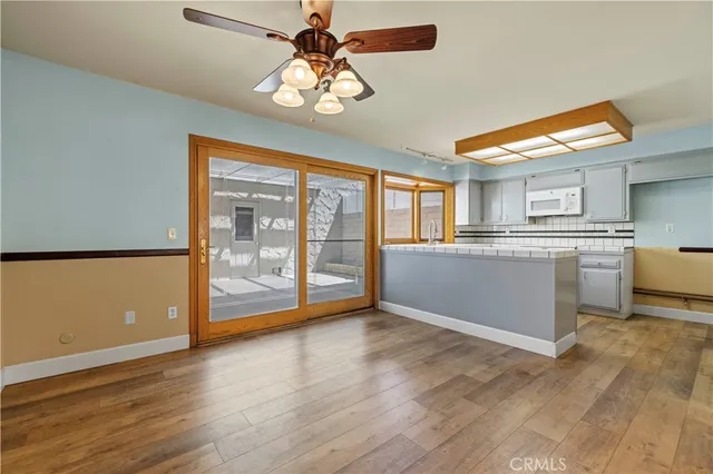 a view of a kitchen with a sink cabinets and wooden floor