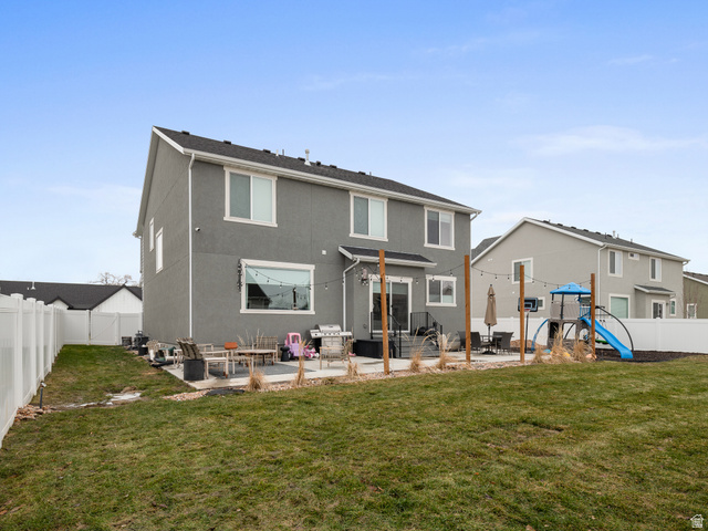627 South Meade Street Mapleton, UT 84664 - Photo 24 of 48 Expansive backyard featuring a manicured lawn, a white vinyl privacy fence, and a patio area