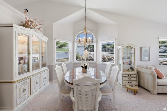 3766 Cardiff Circle Bountiful, UT 84010 - Photo 7 of 46 Dining area with vaulted ceilings, a central chandelier, and a bay window featuring three individual windows