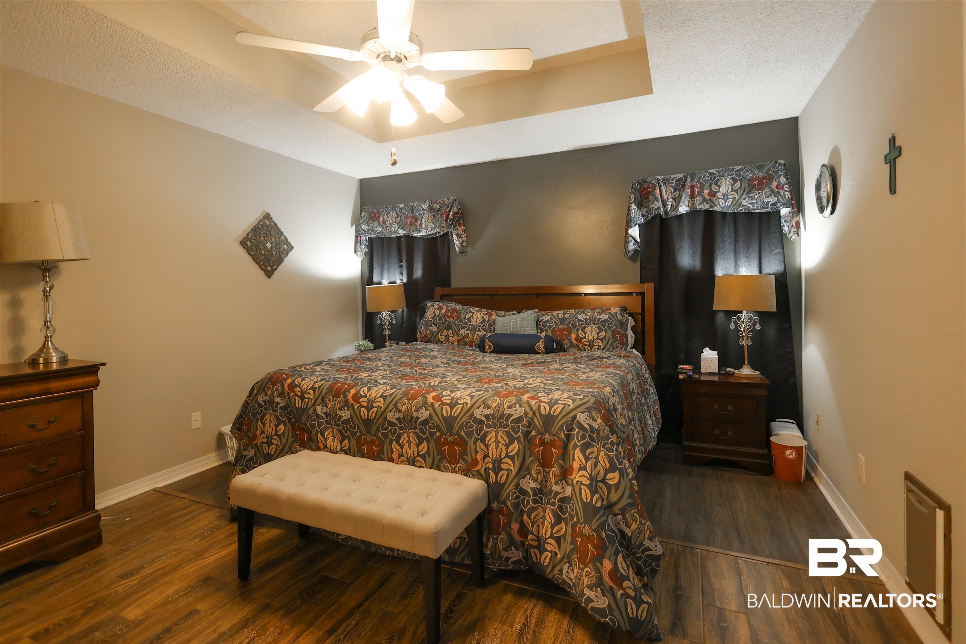 7790 Audubon Drive Foley, AL 36535 - Photo 17 of 39 Room featuring wood-finish flooring, a tray ceiling, and a ceiling fan with integrated lighting