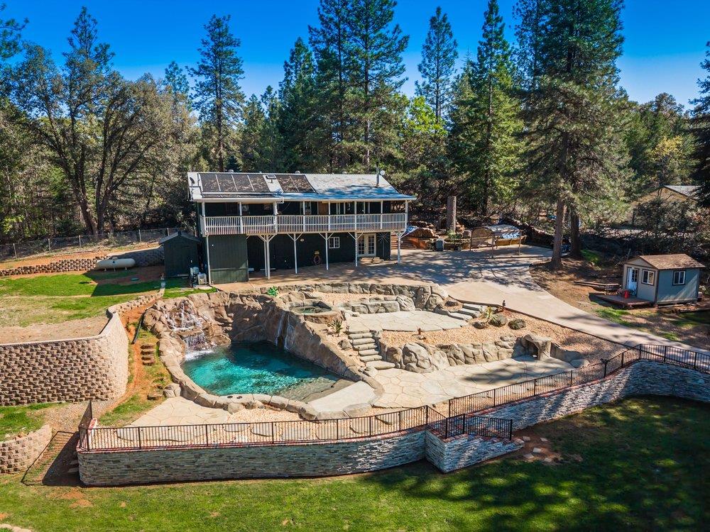 a view of a house with swimming pool and sitting area