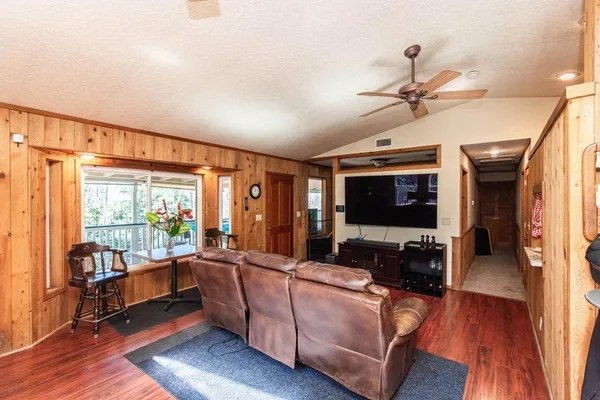 a kitchen with granite countertop stainless steel appliances cabinets a sink and a large window