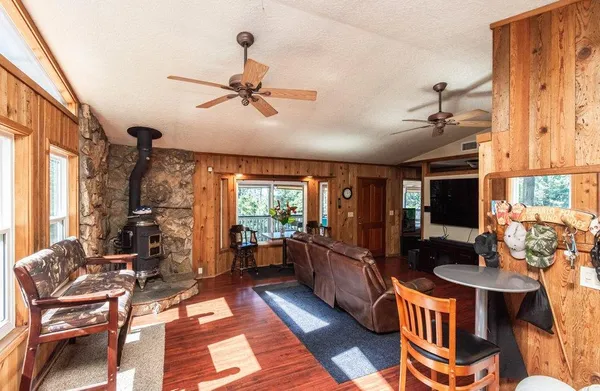 a bathroom with a granite countertop sink a mirror a toilet and a shower