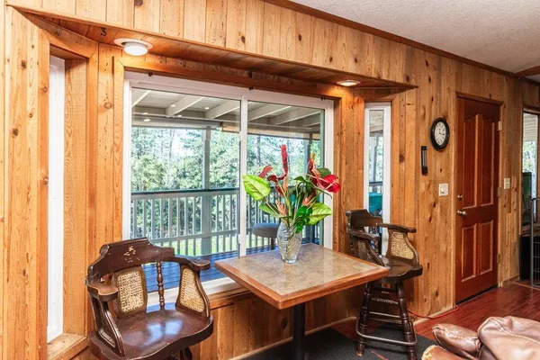 an aerial view of a house with a yard and large trees
