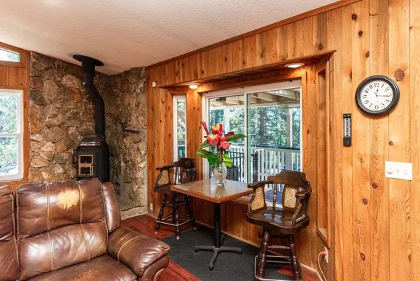 an aerial view of a house with garden space ocean and trees all around