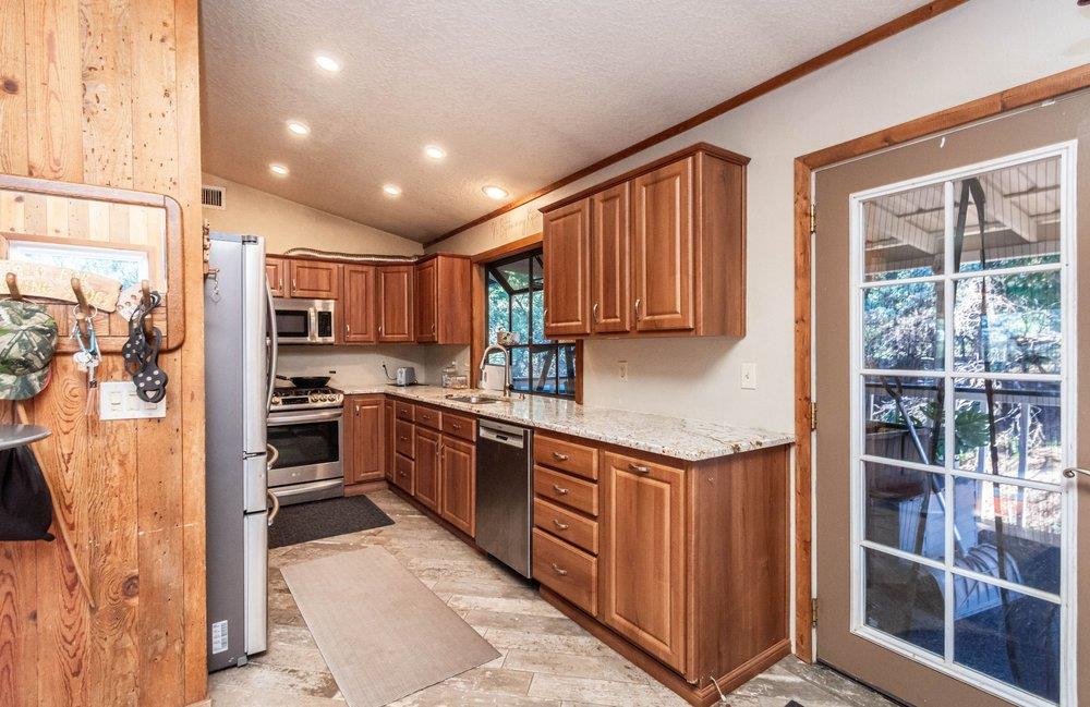 23870 Tokayana Way Colfax, CA 95713 - Photo 35 of 93 a kitchen with stainless steel appliances granite countertop a refrigerator and a stove top oven