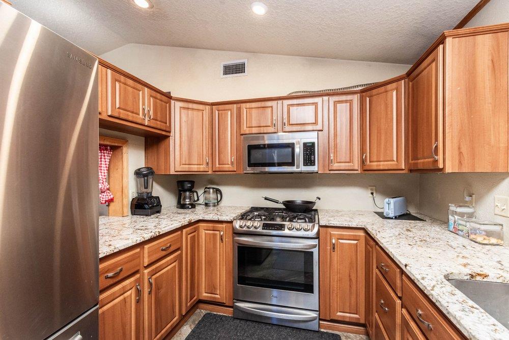 23870 Tokayana Way Colfax, CA 95713 - Photo 39 of 93 a kitchen with stainless steel appliances granite countertop a stove sink and cabinets
