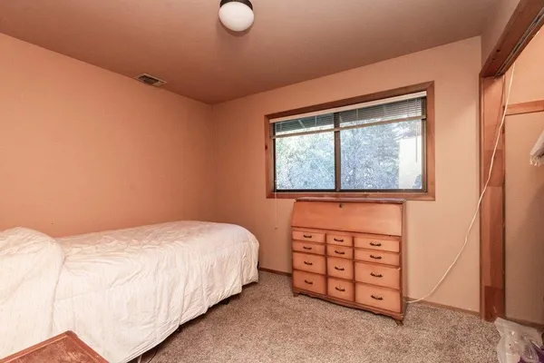 an aerial view of a house with a yard and garden