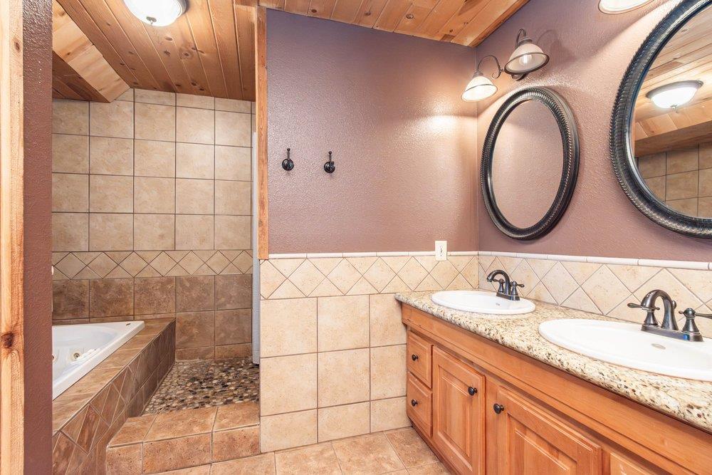 23870 Tokayana Way Colfax, CA 95713 - Photo 48 of 93 a bathroom with a granite countertop sink and a mirror