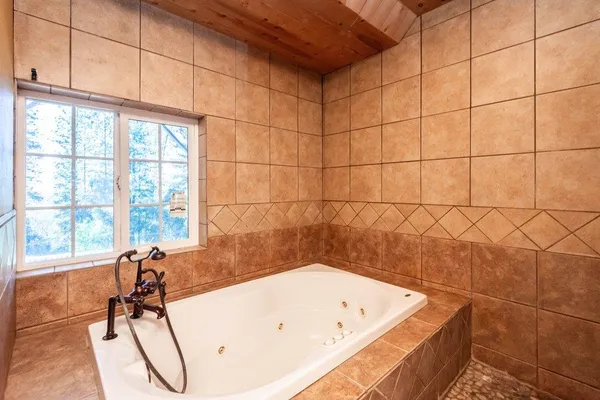 a view of a house with backyard sitting area and garden