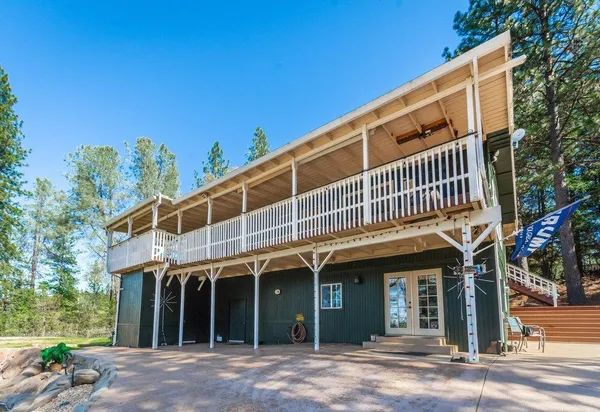 a view of a house with a yard covered with snow in the background