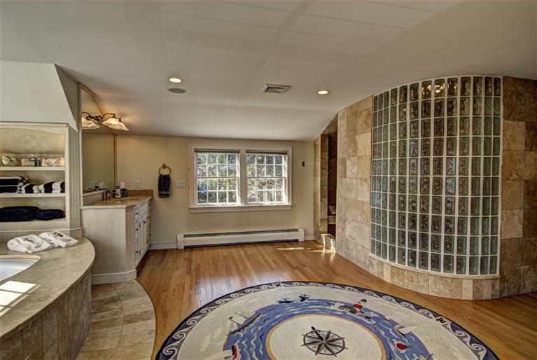 80 Salten Point Road Barnstable, MA 02630 - Photo 6 of 21 a living room with a couch and a stove next to a window