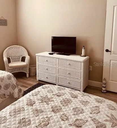 a bedroom with a bed and a television