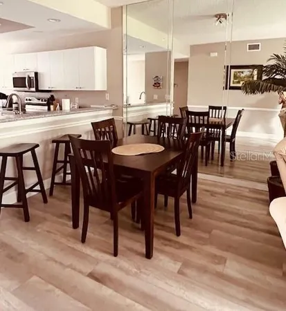 a large kitchen with a table and chairs