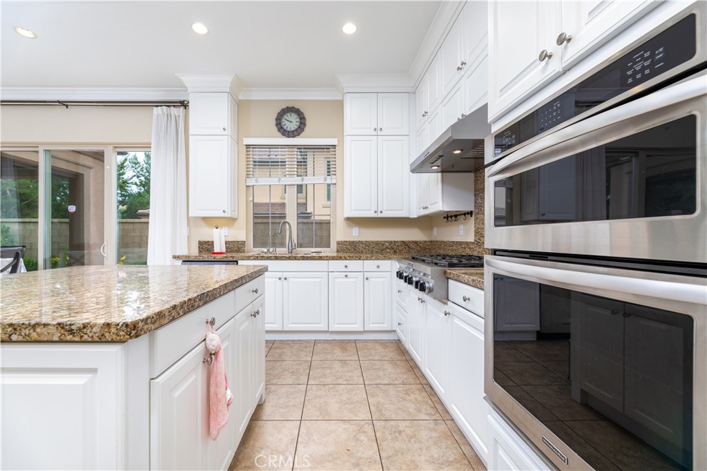 71 Thornapple Irvine, CA 92620 - Photo 18 of 33 a kitchen with stainless steel appliances granite countertop a stove and a sink