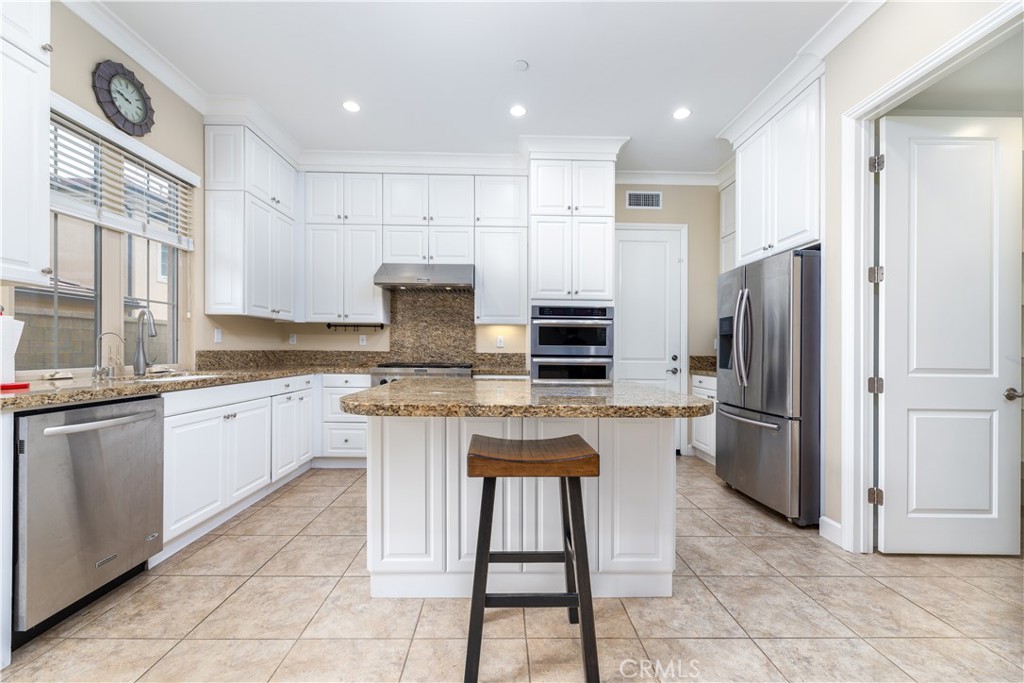 71 Thornapple Irvine, CA 92620 - Photo 21 of 33 a kitchen with stainless steel appliances granite countertop a stove a sink and a refrigerator