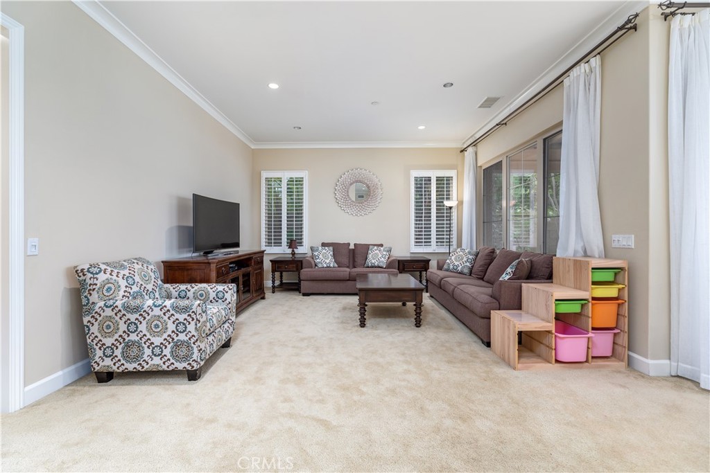 71 Thornapple Irvine, CA 92620 - Photo 22 of 33 a living room with furniture and a flat screen tv