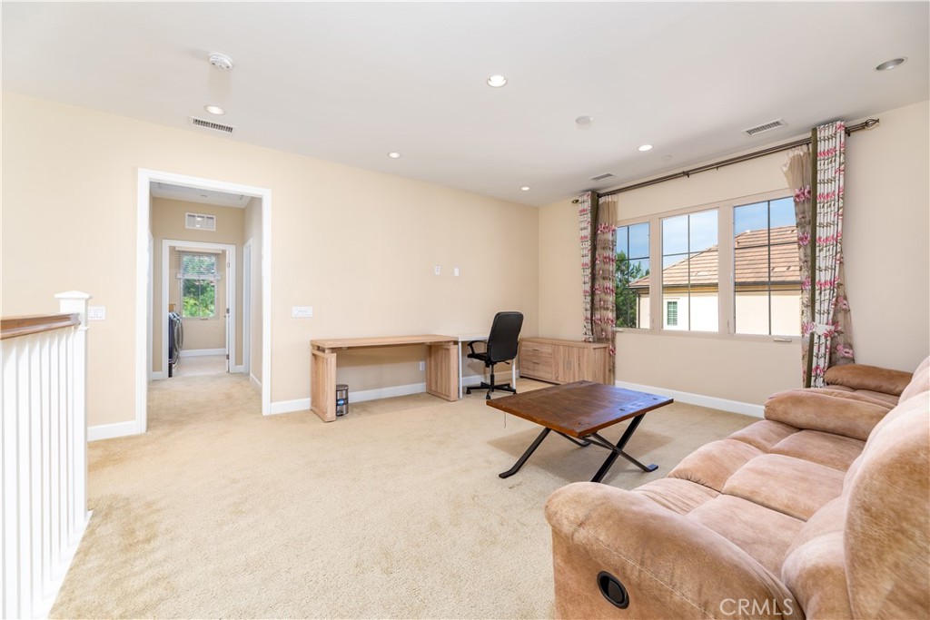 71 Thornapple Irvine, CA 92620 - Photo 6 of 33 a view of a livingroom with workspace and a window