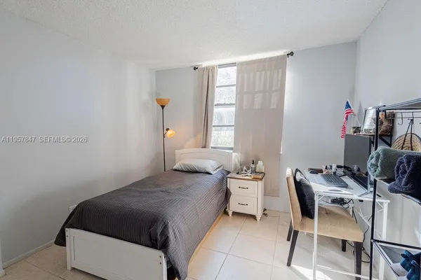 a bedroom with a bed and a chair