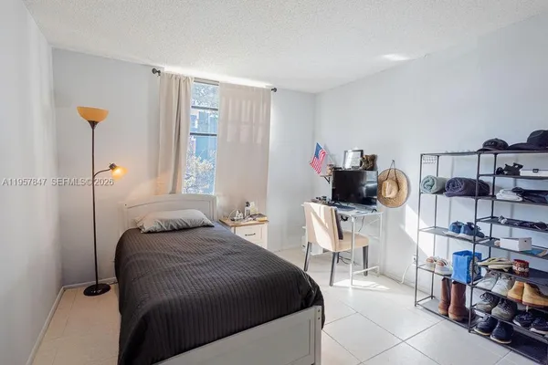 a bedroom with a bed and a book shelf
