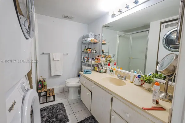 a bathroom with a sink a toilet and a mirror