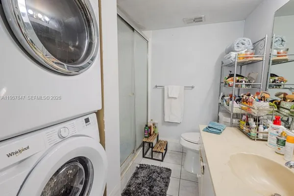 a utility room with sink dryer and washer