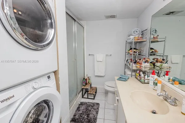 a bathroom with a sink vanity mirror and toilet