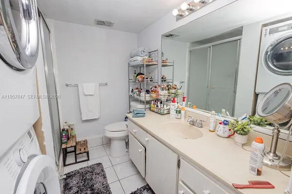 a bathroom with a sink a toilet and shower curtain