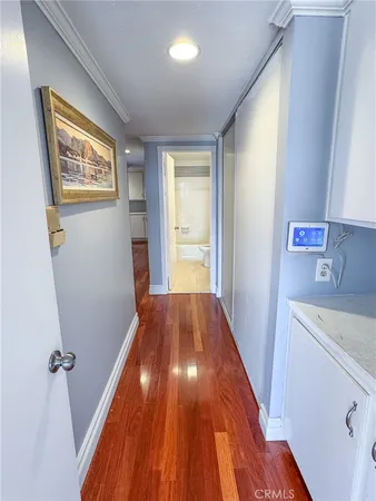 a view of a hallway with wooden floor and staircase