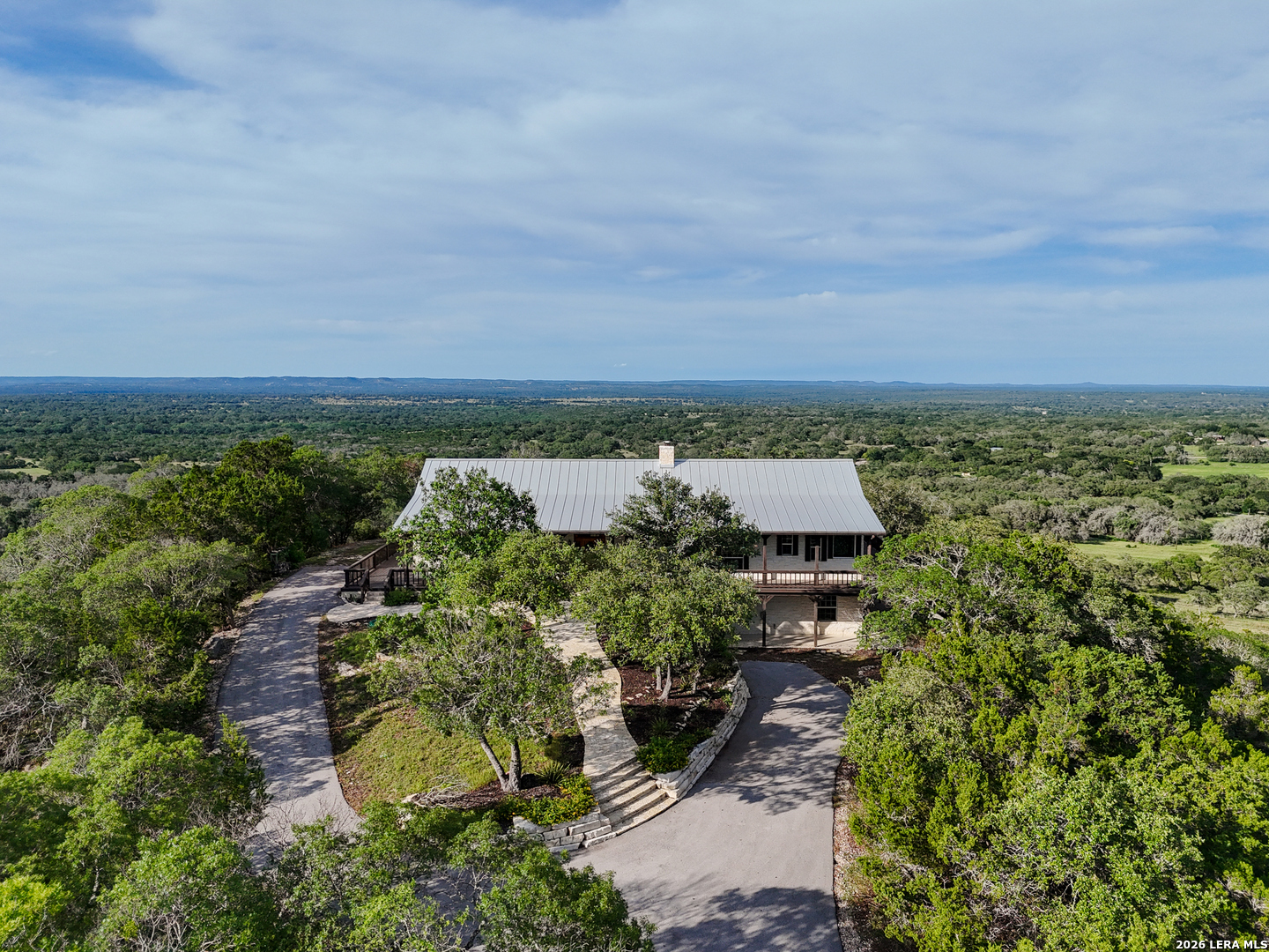 26 Seewald Road Boerne, TX 78006 - Photo 2 of 33 an aerial view of a house with a yard and lake view