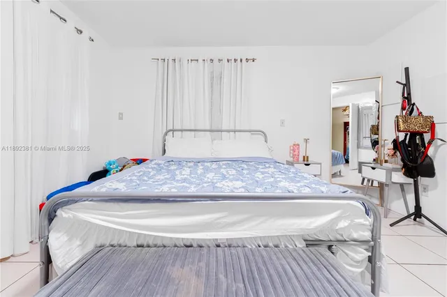 a bedroom with a bed and a mirror