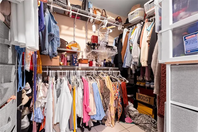 a view of walk in closet with clothes