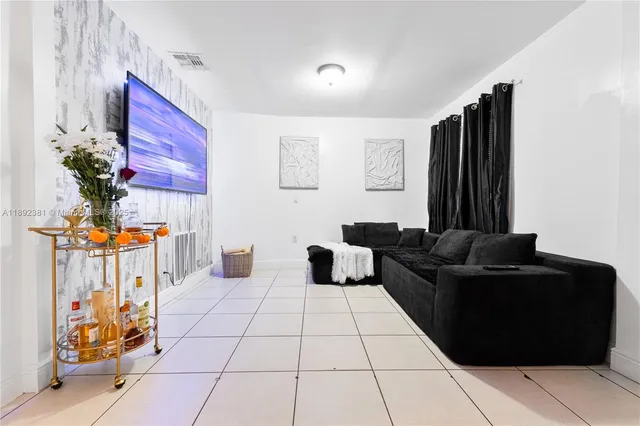 a living room with furniture and a potted plant