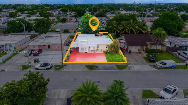 an aerial view of house with yard swimming pool and outdoor seating