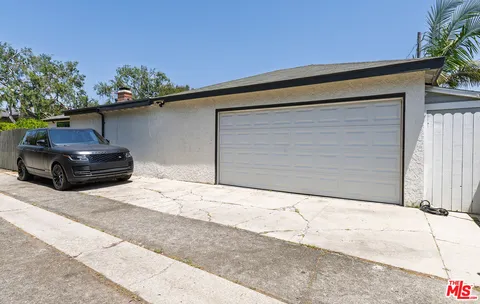 a black car parked in front of a house