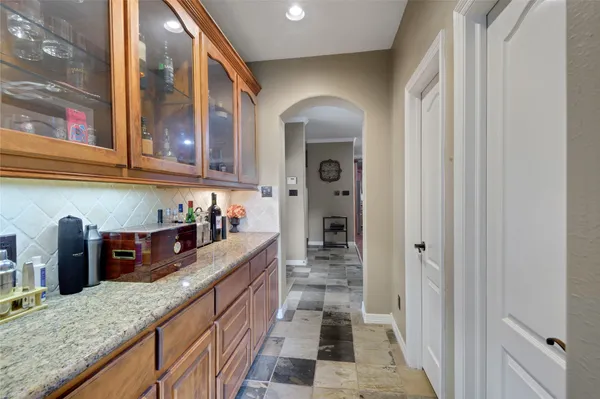 a living room with stainless steel appliances furniture and a view of kitchen