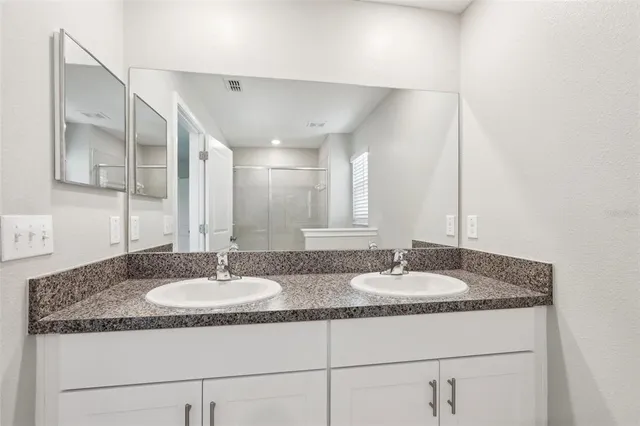 a bathroom with a glass shower door
