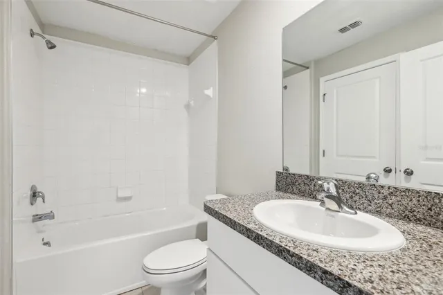 an empty room with closet and windows