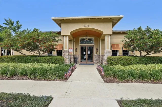 an aerial view of a house with garden space and swimming pool