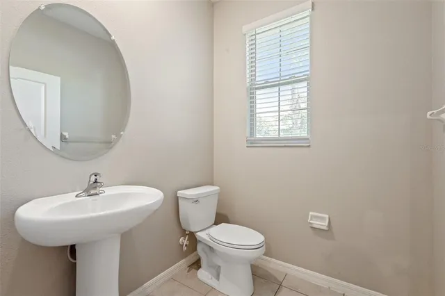 a kitchen with granite countertop a stove sink and refrigerator