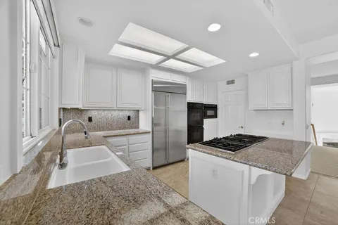 a white stove top oven sitting inside of a kitchen