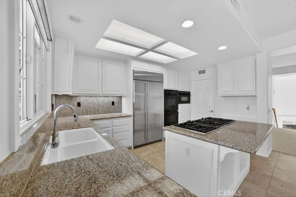 a white stove top oven sitting inside of a kitchen