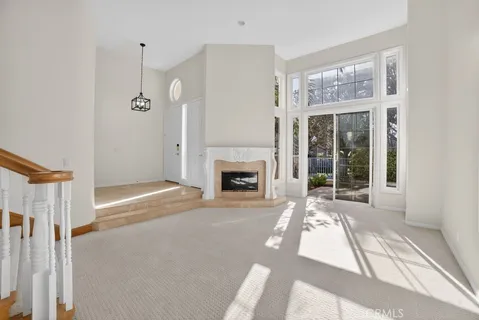 a view of a house with a floor to ceiling windows and yard