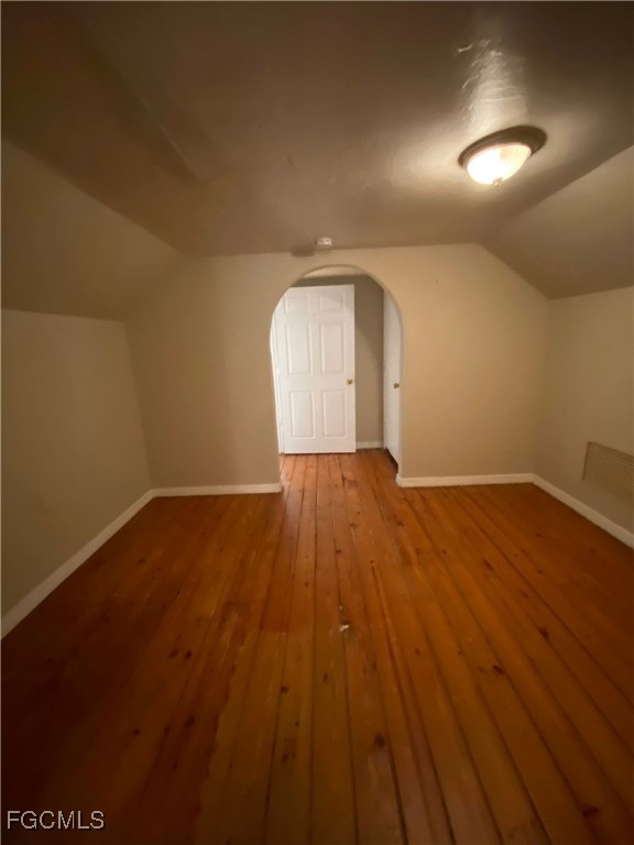 2210 Cantor Lane, Unit B North Fort Myers, FL 33917 - Photo 5 of 9 an empty room with wooden floor and windows