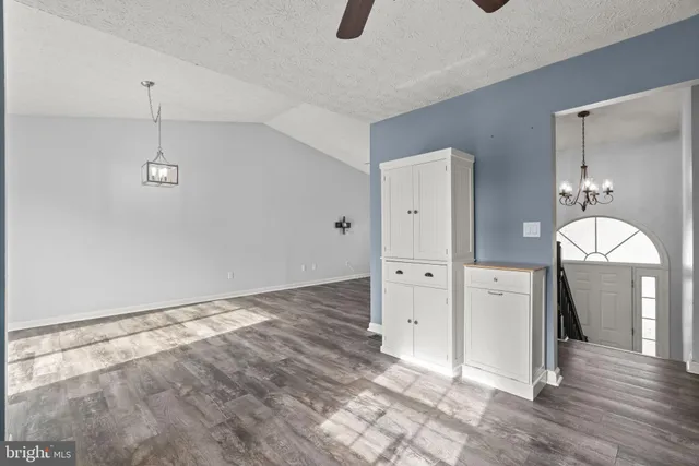 a view of a room with wooden floor and cabinet